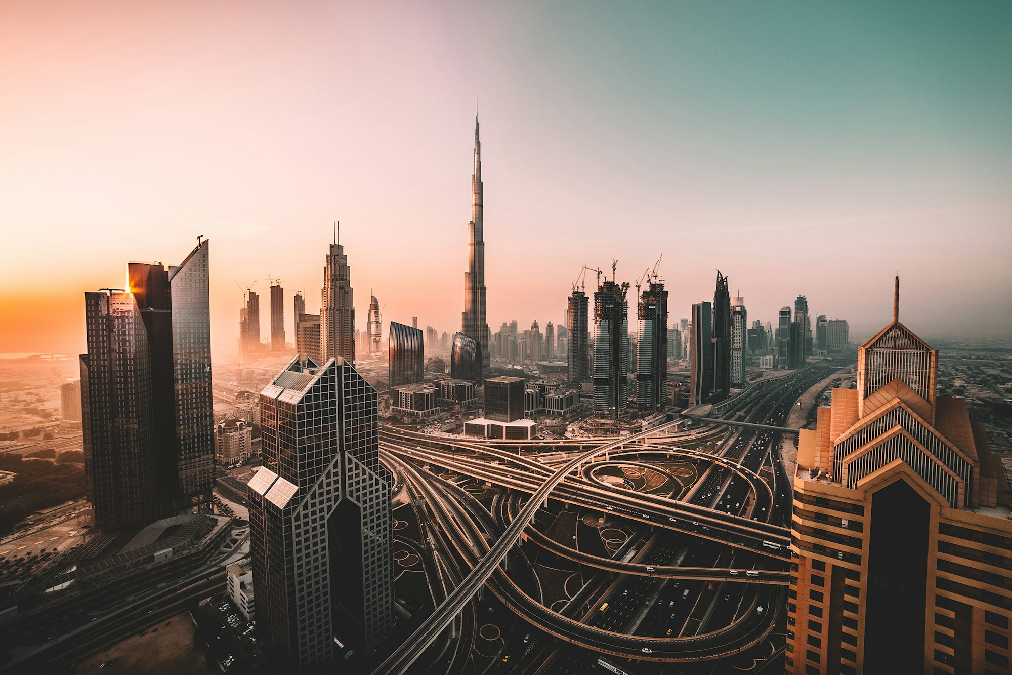Dubai's skyline and interconnected roads at sunset